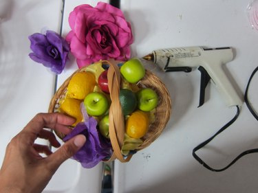 Making basket of fruit and flowers.