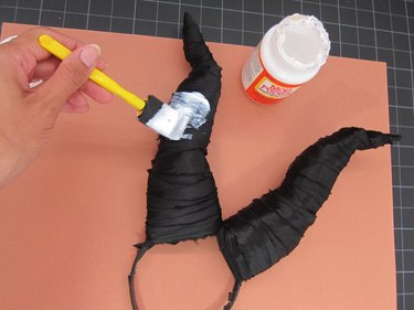 Painting the horns with Mod Podge