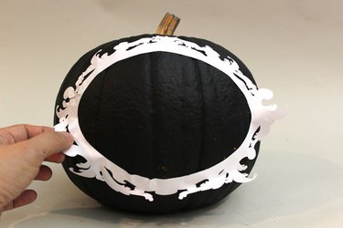 Place a vinyl decal frame on the painted pumpkin