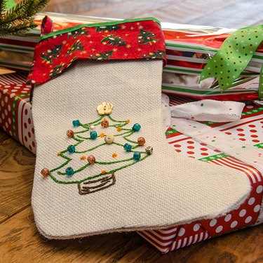 Fireplace decorated with Christmas stockings and Poinsettias