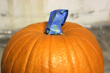 Tape the stem of the pumpkin