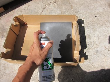 Spraying foam sheet with adhesive