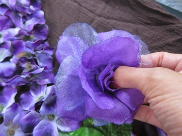 Gluing a flower to the costume