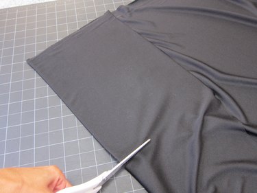 Trimming fabric with scissors