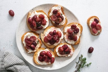 Slices of toast topped with mascarpone and roasted grapes