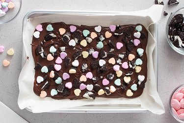 Melted chocolate with candy hearts and crushed Oreos