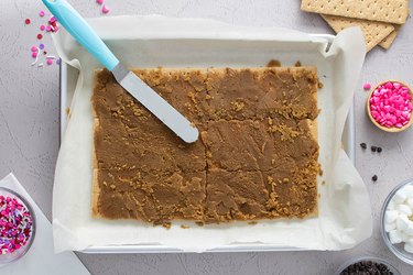 Spreading toffee on graham crackers