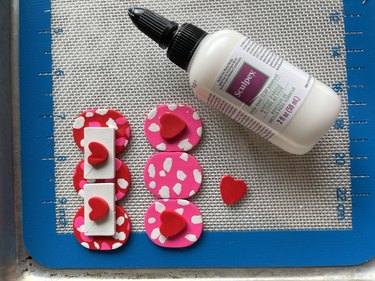 Two Valentine's Day-themed polymer clay barrettes with a polymer clay glue bottle