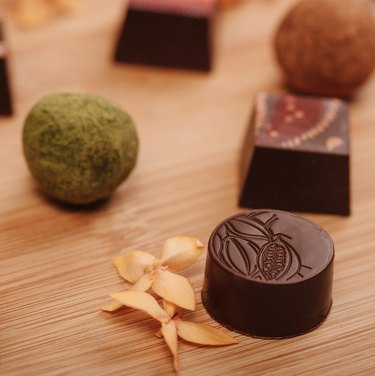 An assortment of Midunu chocolates against a wooden countertop