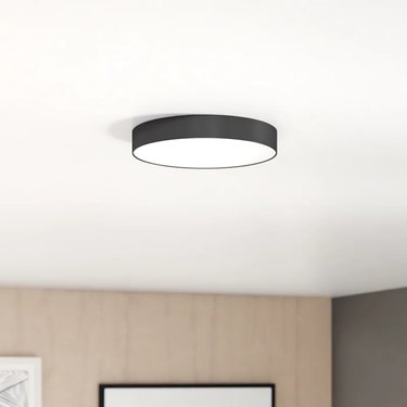 Round LED light flush mount on white ceiling.