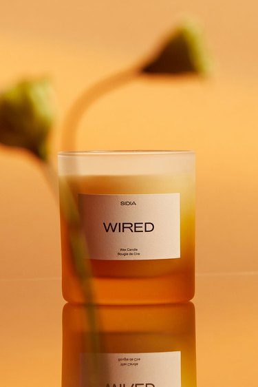 Wired Candle from SIDIA with an ombre glass vessel in shade of orange, yellow, and white.