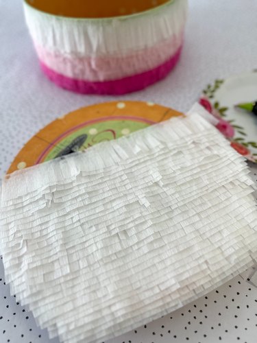 cover the lid with fringed crepe paper strips