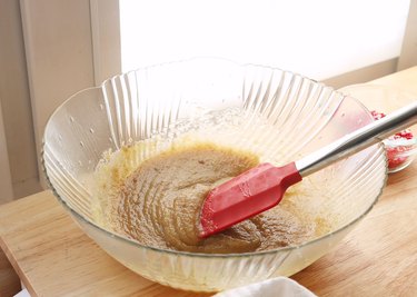 Butter and sugar mixed together in a glass mixing bowl