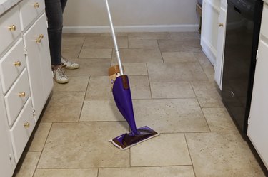 Cleaning tile floor with a wet mop