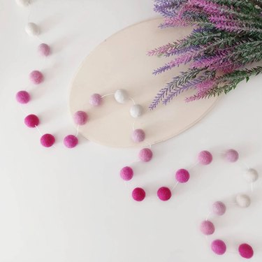 Wool ball garland in shades of hot pink, fuchsia and white