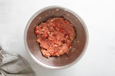Meatball mixture in a stainless steel bowl