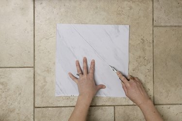 Cutting vinyl floor tile with a utility knife