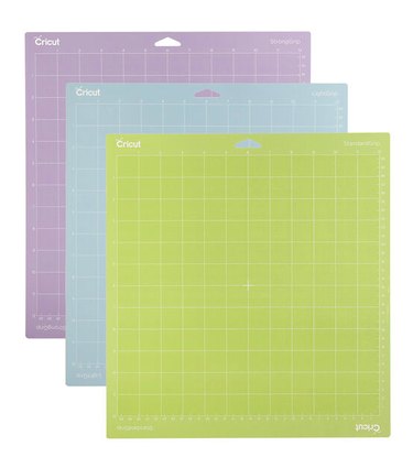 Three Cricut cutting mats in purple, blue and green