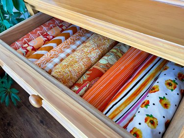 color-coordinated fabric rolled up in a drawer
