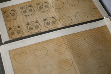 Jigglypuff and heart macaron templates placed underneath silicone mats
