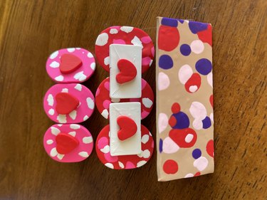 A close-up of three polymer clay barrettes for Valentine's Day