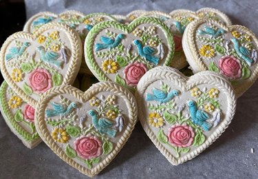 Heart-shaped cookies featuring flowers and blue birds