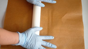 Rolling dough between sheets of parchment paper