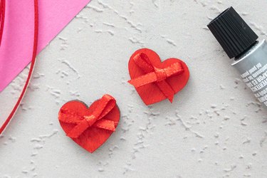 Glue tiny bows on wooden hearts