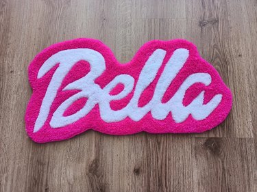 Rug with "Bella" written in Barbie font