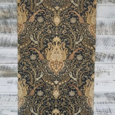 Intricate damask wallpaper in gold, cream and black