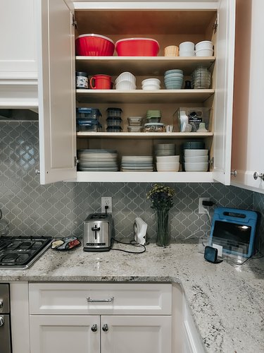 Decluttered kitchen cabinet with plates and bowls