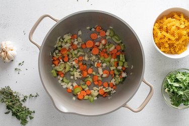 Cooked onion, celery and carrots in a large pot