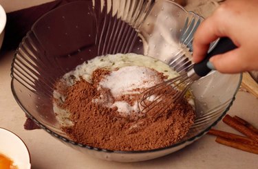Glass mixing bowl with melted butter, sugar and cocoa powder