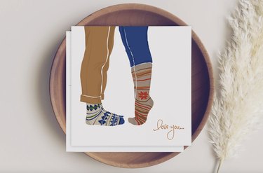 Legs with cozy socks on a white card