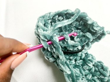 crochet hook connecting the top and bottom to create tube