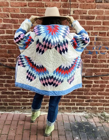 Multicolored quilt jacket on woman wearing hat