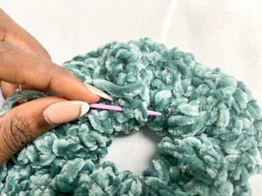 Needle sewing ends of scrunchie closed