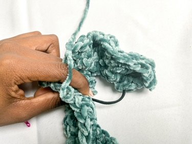 Pinching crochet tube to create space around hair tie