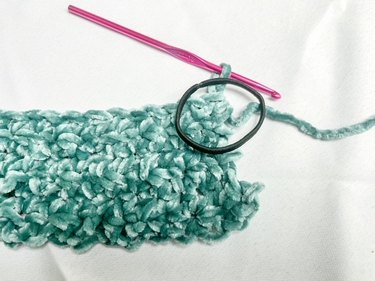 Hair tie placed on the corner of crocheted work