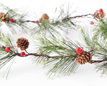 Greenery garland with red berries and pinecones