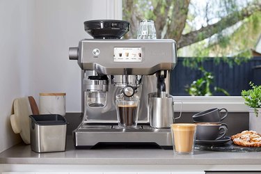 Breville espresso machine on a gray countertop.