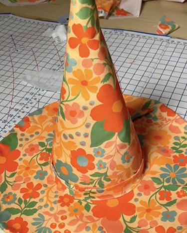 Witch hat made with orange, green, blue and pink floral fabric