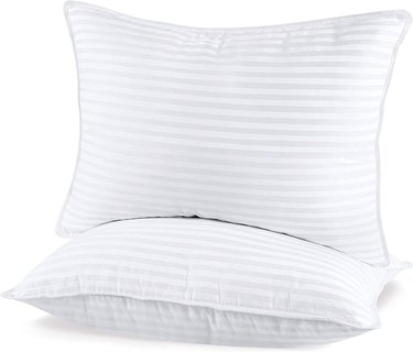 Two queen sized pillows with an elegant stripe design on them.