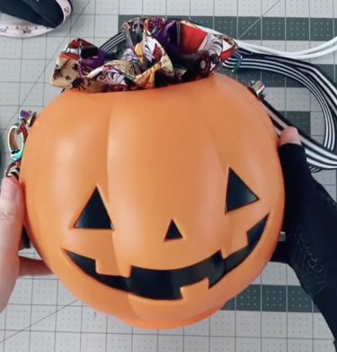 Purse with striped strap made from plastic pumpkin