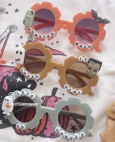 Three pairs of sunglasses with alphabet beads and Halloween charms