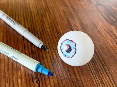 drawing eyes on ping pong balls with markers