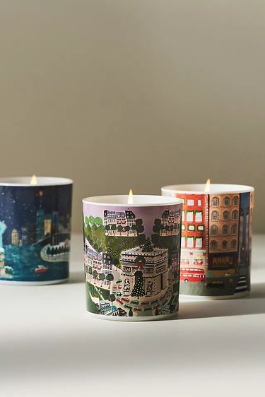 Three Holiday in the City Candles with illustrations of Paris, New York, and London.