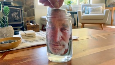 put the laminated face photo in the water-filled jar