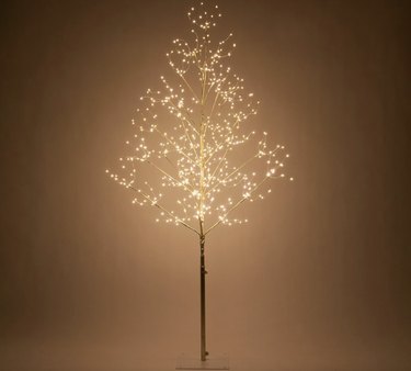 Light up LED fairy tree with a gold metal skinny trunk and square base.