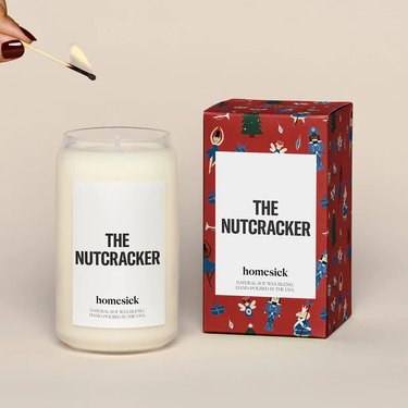 Homesick "The Nutcracker" Candle in a tall glass jar with a white label and bold black lettering.